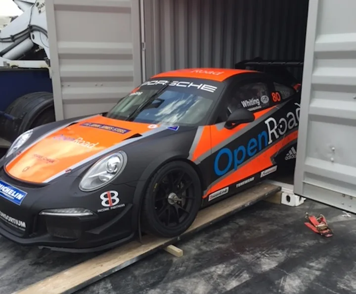 Porsche race car secured inside a shipping container for motorsport transport
